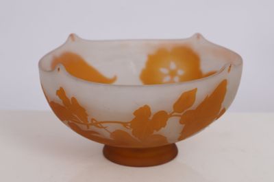 an orange and white bowl sitting on top of a table