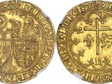 a gold coin with a cross on the front and a shield on the back