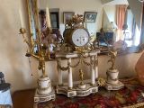 a table with a clock on it in front of a mirror