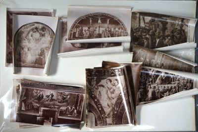 a lot of old photos in a box on the table