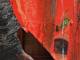 a red piece of art with a hole in the middle of it