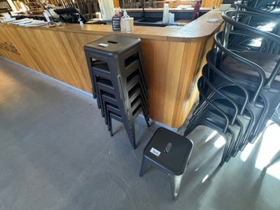 de nombreuses chaises et tables dans un restaurant avec un bar