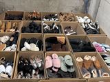 many pairs of shoes in a box on the floor