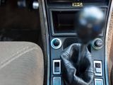 a close up of a car ' s dashboard with a hand pressing a button
