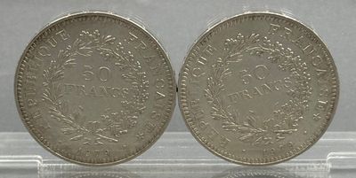 a close up of two silver coins on a clear surface
