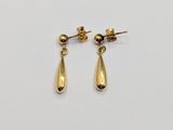 a pair of gold earrings on a white background