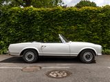 an image of a white convertible car parked in a parking lot