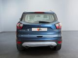 the rear end of a blue ford kuga parked in a room