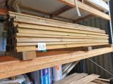 many pieces of wood stacked on the shelves in the garage