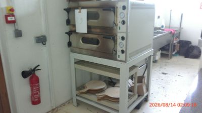 a stack of ovens sitting on a cart in a kitchen