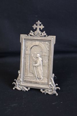 an old silver picture frame with a picture of a man holding a cross
