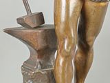 bronze statue of a man with a hammer and an anvil