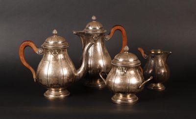 four pieces of silver tea and coffee set on a black background