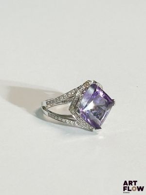 a close up of a ring with an amethorate and diamonds