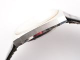 a close up of a watch on a white surface