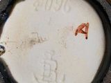a close up of a vase with a brown lid