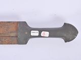 a knife that is laying on top of a piece of wood