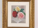 painting of roses in a gold frame on a white wall