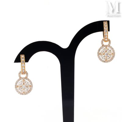 a close up of a pair of earrings on a stand