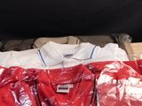a red shirt on a table with other items on it