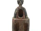 a small statue of a person sitting on a bench