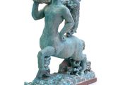 statue of a man riding a horse with a bird on its back
