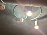 three light bulbs that are on the ceiling of a room