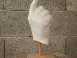 a sculpture of a hand with a glove on top of it