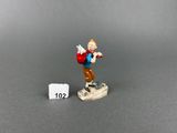 a close up of a figurine of a man on a skateboard