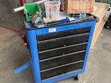 a blue workbench with tools on it in a garage