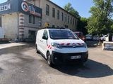 a white van that is parked in front of a building
