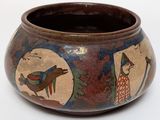 a small vase with a fish design on it