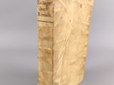 an old book sitting on top of a white surface