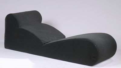 a black couch that is sitting on a white surface