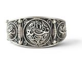 a close up of a silver ring with a bird on it