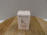a box of kerastase cream sitting on a wooden table