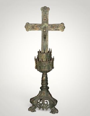 an image of a cross on a pedestal with a white background