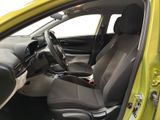the interior of a yellow car with black seats and a steering wheel
