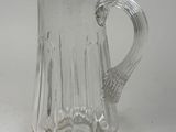 a glass pitcher that is sitting on a table