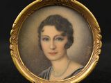 an antique portrait of a woman with a pearl necklace in a gold frame