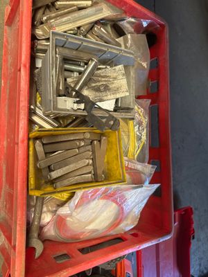 a red box filled with assorted tools in a garage
