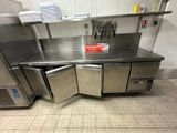 un plan de travail en inox sur lequel sont posés tout un tas de plats