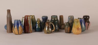 a lot of vases that are sitting on a table