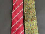two neck ties with different designs on them sitting on a table