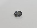 a blue sapphire stone on a white surface