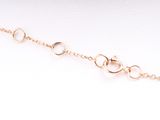 a close up of a gold chain with circles on it