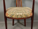 a wooden chair with a floral upholstered seat