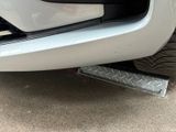 a close up of a car ' s bumper with a flat tire