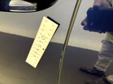 a sticker on the door of a car that has a sticker attached to it