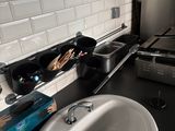 a white sink sitting next to a stove in a kitchen
